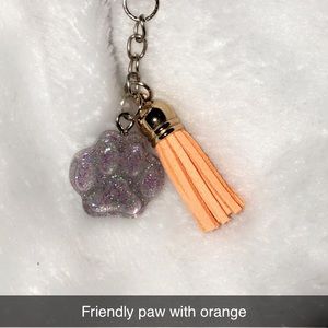 Friendly paw keychain with orange fringe